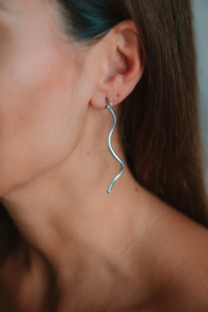 FLOW silver wave earring worn on the ear